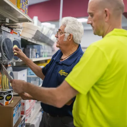 Kamco employee in store helping customer find products 
