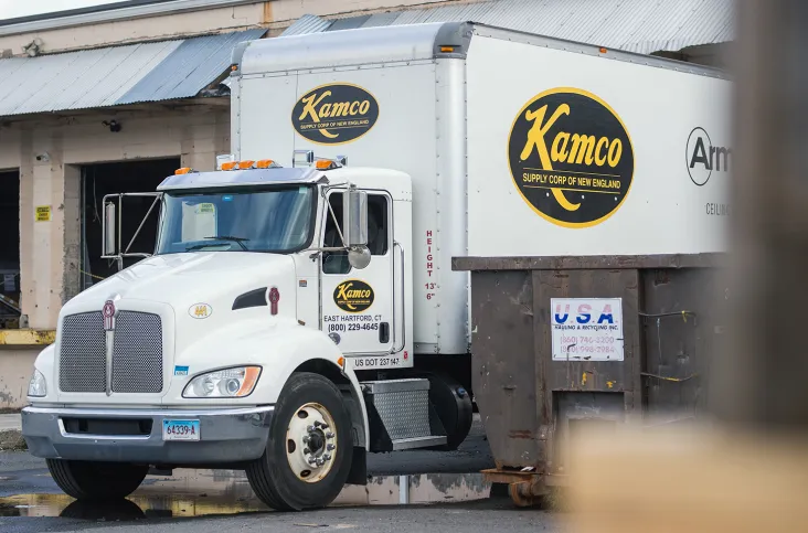 Kamco delivery truck at warehouse loading deck